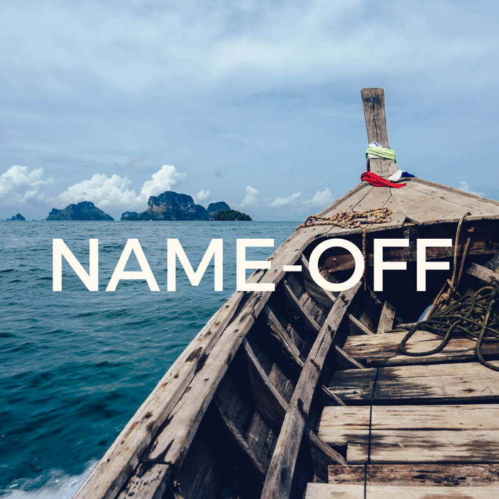 Old fishing boat on dark blue open water with island in the background and white puffy clouds in the sky.