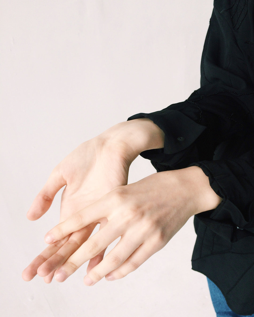 woman wearning black sweater showing beautiful hands