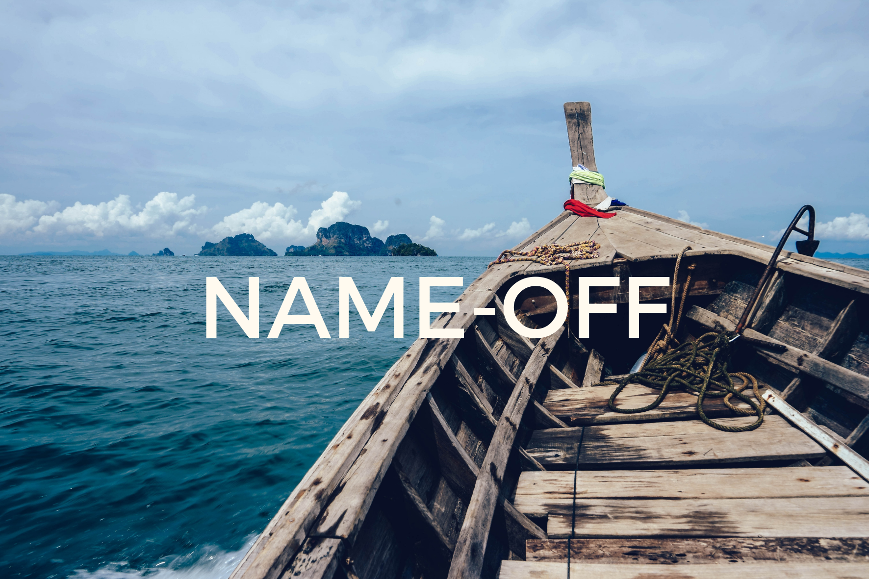 Old fishing boat on dark blue open water with island in the background and white puffy clouds in the sky.