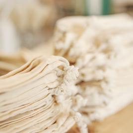 Organic muslin bags stacked in bundles with natural background